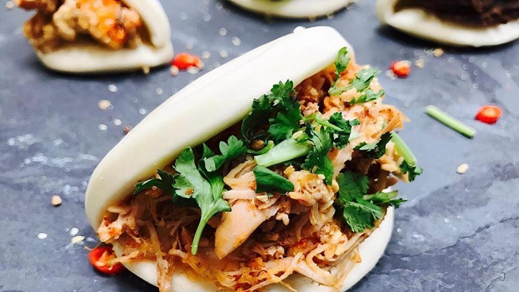 Red Curry Chicken Bao · Spicy. Red curry chicken, carrot, red onion, cilantro, crispy shallots and green sauce. Mild spicy.