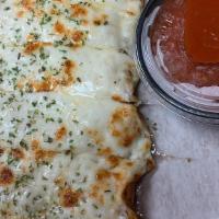 Cheesy Breadstrips · Mozzarella cheese baked over bread strips served with a side of Marinara dipping sauce