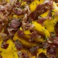 Loaded Waffle Fries  · Waffle fries loaded with crispy bacon and melted Cheddar cheese