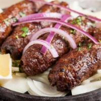 Lamb Seekh Kebab · minced lamb rolled on a skewer marinated in jalapeño peppers, black peppers, nutmeg powder a...