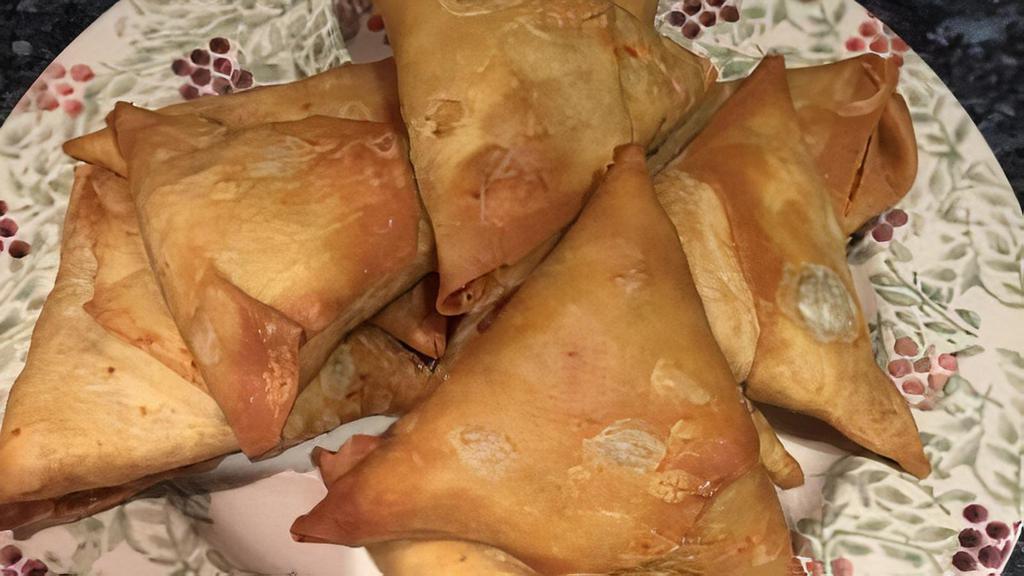 Two Veggie Samosa · Samosa is a fried with a savoury filling, spiced potatoes, onions & peas..