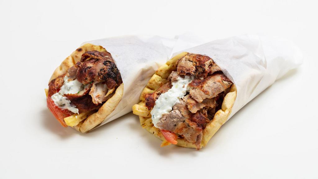 Lamb Gyro Pita Sandwich · Marinated lamb served with shredded lettuce, diced tomatoes, chopped onions and house made tzatziki sauce on pita bread.
