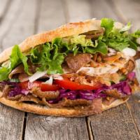 The Combo Gyro Pita Sandwich · Exquisite classic sandwich with both lamb and chicken gyro meat on pita sandwich!