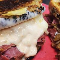 Grilled Reuben · Grilled corned beef with grilled kraut, Swiss cheese and Russian dressing on grilled rye.