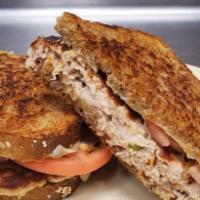 Tuna Melt · Grilled all-white tuna salad with tomatoes and melted Swiss on grilled whole wheat bread.