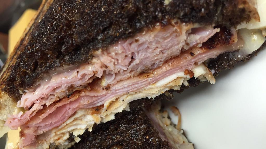 Monte Cristo · Grilled ham, turkey, Swiss and mustard on grilled rye.