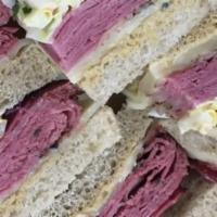 New York, New York · Hot corned beef and pastrami with Swiss cheese, coleslaw, and mustard on triple-decker seede...