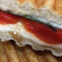 Sopranos Panini · Fresh mozzarella, roasted red peppers, basil, balsamic, olive oil and seasonings on flatbread.