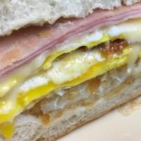 The Great Hambino · Grilled ham, bacon, two eggs, Swiss cheese and a hash brown on a roll.