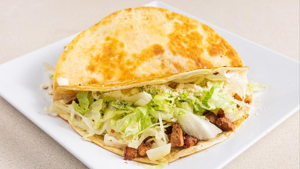 Al Pastor Quesadillas · Flour or corn tortilla with cheese, lettuce, Cotija cheese and sour cream.