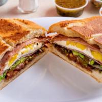 Cubana Torta · Traditional Mexican sandwich served on a telera toasted bread with refried beans, mayo, slic...