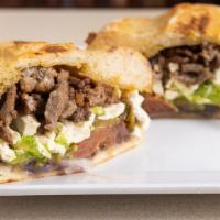 Steak Torta · Traditional Mexican sandwich served on a telera toasted bread with refried beans, mayo, slic...