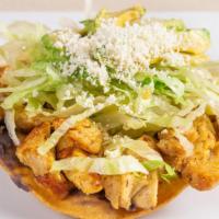 Chicken Tostadas · Crunchy tortilla with refried beans, lettuce, avocado, Cotija cheese and sour cream.