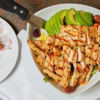 Cobb Salad With Grilled Chicken & Avocado · served on Top of an Assortment of Lettuce, Celery, Carrots, Cheddar Cheese, Black olives, Ba...