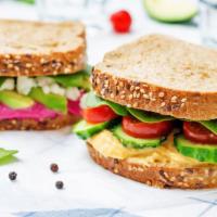 Hummy Sandwich · Creamy, rich hummus with fresh lettuce, tomatoes, cucumbers and sprouts on your choice of br...