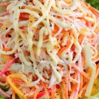 Kani Salad · Shredded crab meat and cucumber tossed in japonnaise and fish roe.