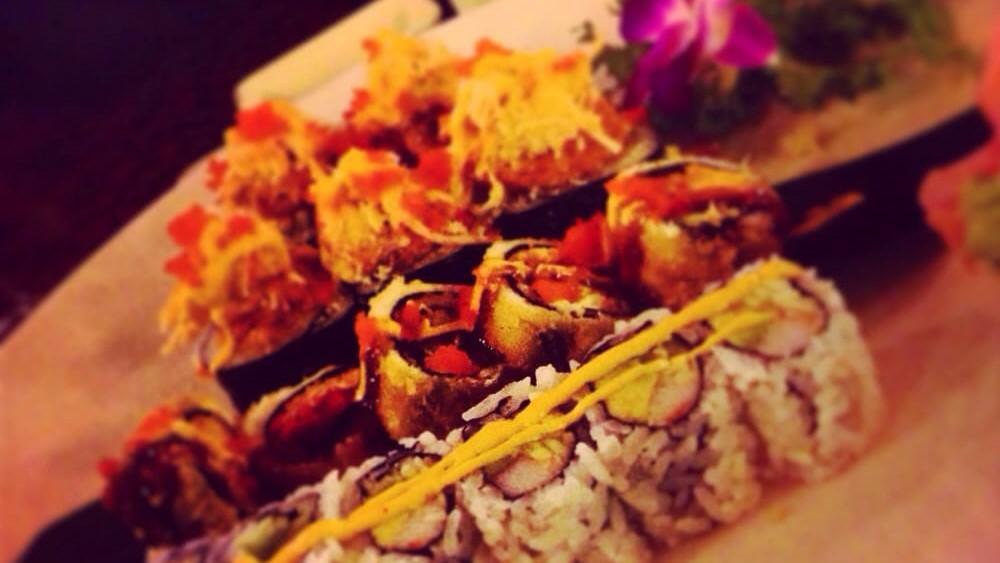 Godzilla Roll · Kani saled with cream cheese and avocado rolled with white fish deep fried topped spicy eel sauce.