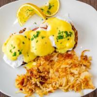 Eggs Benedict · English muffin topped with poached eggs and Canadian bacon, drizzled with our homemade holla...