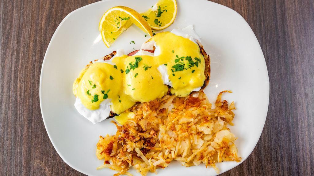 Eggs Benedict · English muffin topped with poached eggs and Canadian bacon, drizzled with our homemade hollandaise sauce.