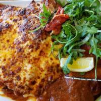 Veal Chop Parmesan · 16 oz breaded bone-in, mozzarella and Parmesan gratinato, San Marzano tomato sauce, wilted s...
