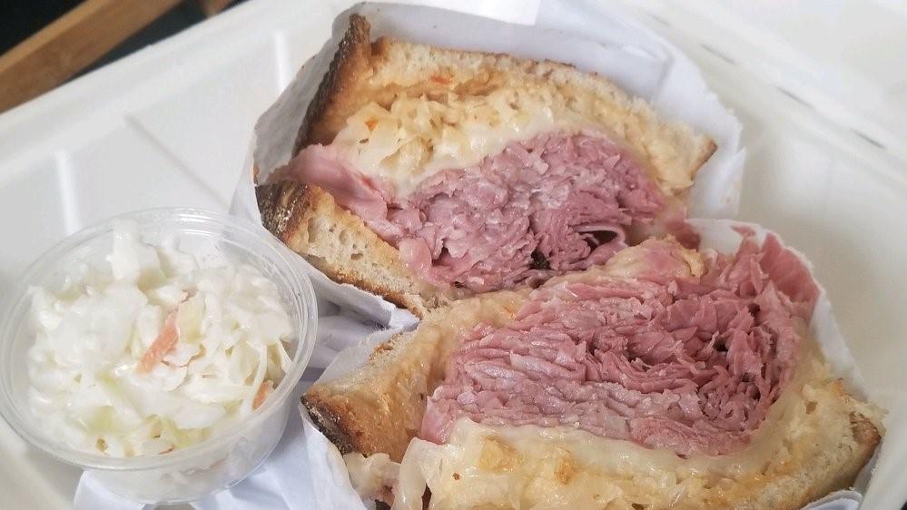 The Reuben · Corned beef, pastrami, or turkey topped with sauerkraut and melted swiss cheese on toasted rye with Russian dressing.