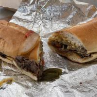 Philly Cheese Steak · Served with cheese, peppers, and onions on a club roll.
