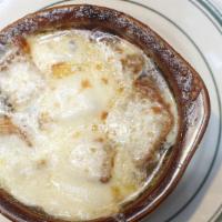French Onion Soup Au Gratin · Spanish onions in a rich beef broth with Croutons and Melted Mozzarella Cheese
