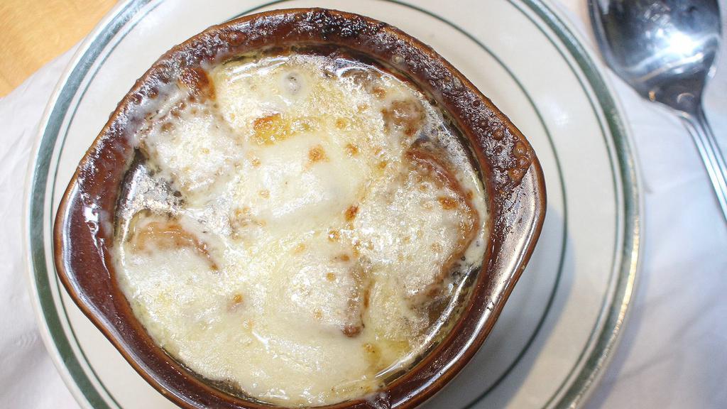 French Onion Soup Au Gratin · Spanish onions in a rich beef broth with Croutons and Melted Mozzarella Cheese