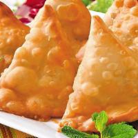 Vegetable Samosa · Triangular shaped turnovers stuffed with delicately spiced, potatoes, green peas, raisins, d...