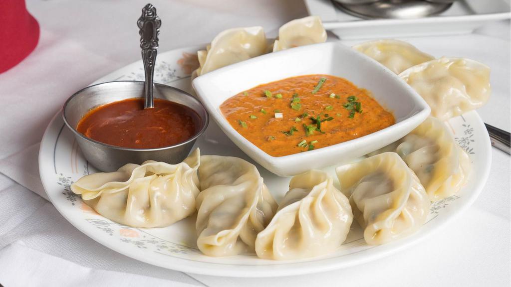 Momo (Dumpling) Chicken- Nepali · Minced chicken marinated in nepali spices stuffed in flour wrap and steamed. Served with a special spicy sauce.