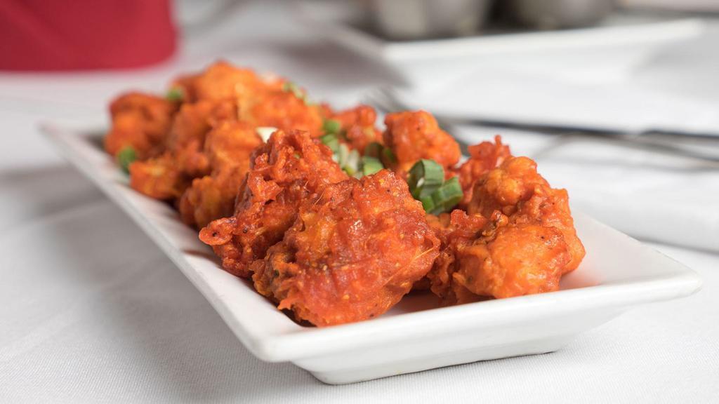 Gobi Manchurian · Cauliflower battered with rice floor and deep fried with sweet & hot sauce.
