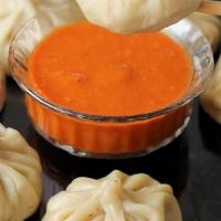 Veg Momo · Minced vegetables marinated in nepali spices stuffed in flour wrap and steamed. Served with ...