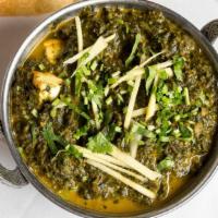 Saag Paneer · Home-made cheese cubes cooked with spinach in creamy onion and tomato sauce.