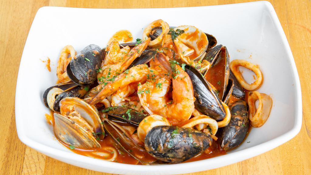 Seafood Linguini · Shrimp, Clams, Mussels & Calamari over Linguini in a White Wine Garlic Tomato Sauce.