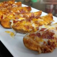 Loaded Potato Skins · Melted cheddar + mozzarella cheese, applewood smoked bacon, with side of sour cream.