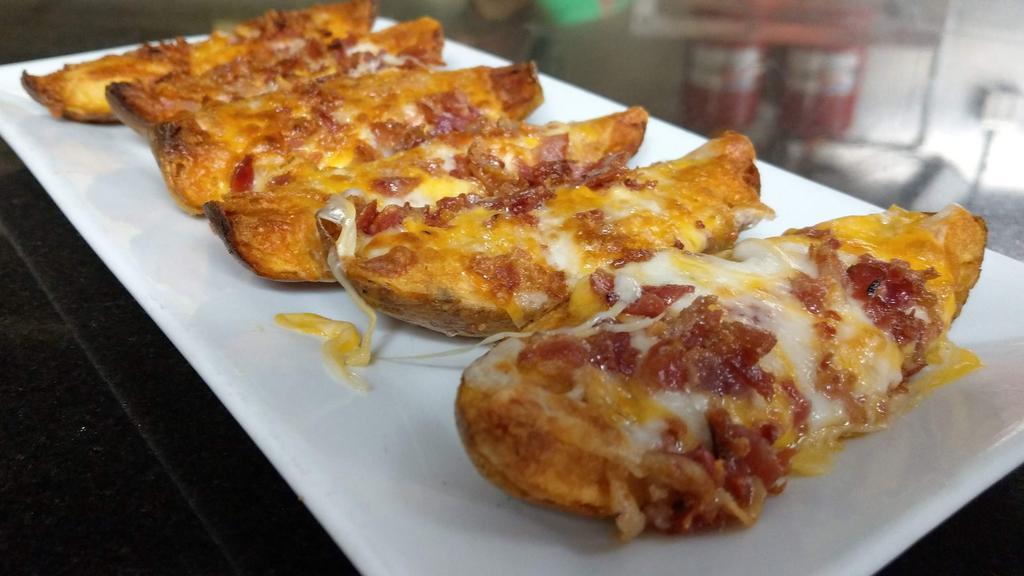 Loaded Potato Skins · Melted cheddar + mozzarella cheese, applewood smoked bacon, with side of sour cream.