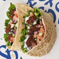 Falafel Pita · Falafel pieces with tomatoes, cucumber, onions, and your choice of sauce wrapped in a pita
