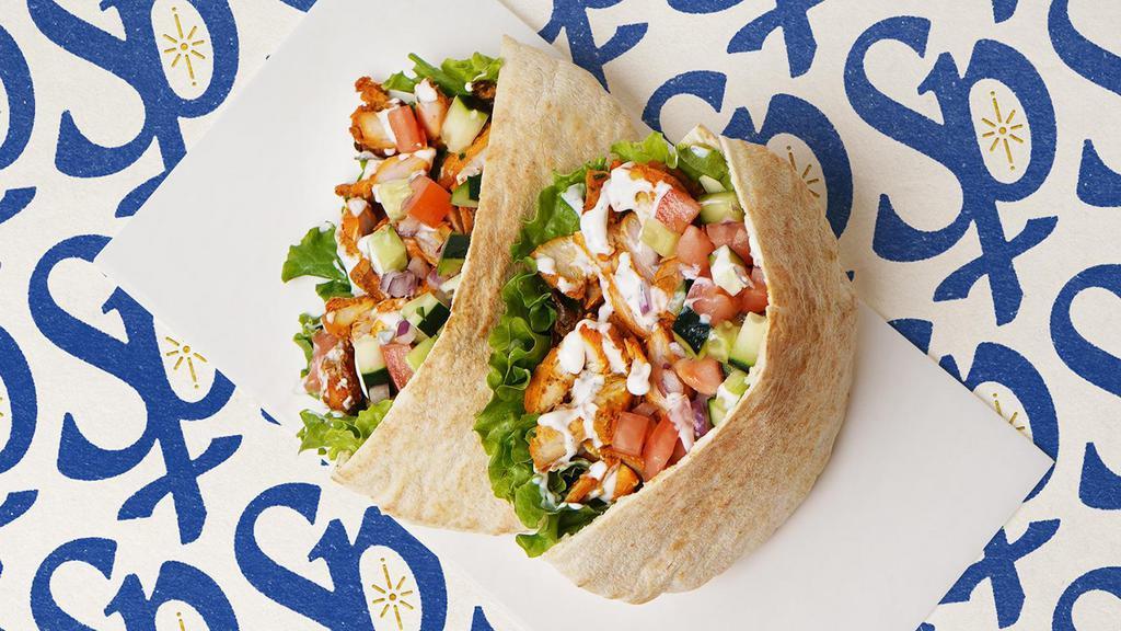 Chicken Shawarma Pita · Chicken shawarma with tomatoes, cucumber, onions, and your choice of sauce wrapped in a pita.
