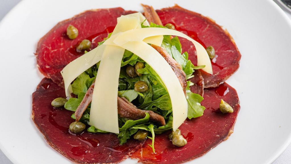 Bresaola · Thinly sliced cured Dried Beef, Arugula Salad with Parmesan Cheese, Anchovies and Capers.