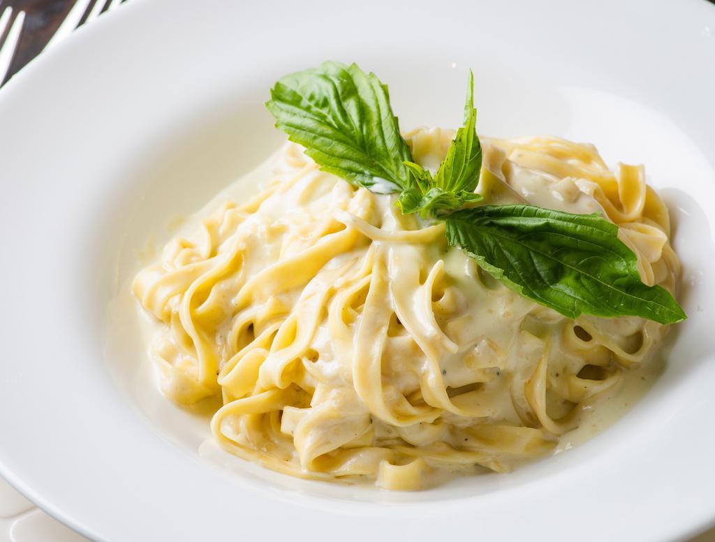 Four Cheese Tagliatelle · Homemade Fettuccine sauteed with Four Cheeses in a Creamy Sauce.