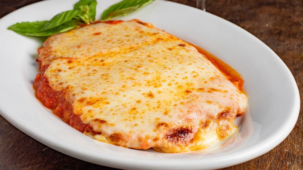 Chicken Parmigiana · Chicken breast lightly breaded and pan fried with tomato sauce and mozzarella, served with penne