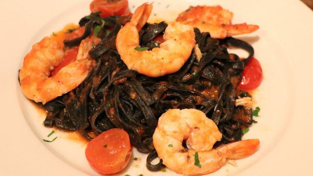 Linguine Al Nero Di Seppia With Seafood  · Homemade Squid ink Linguine with mussels, clams , calamari and shrimp in tomato sauce