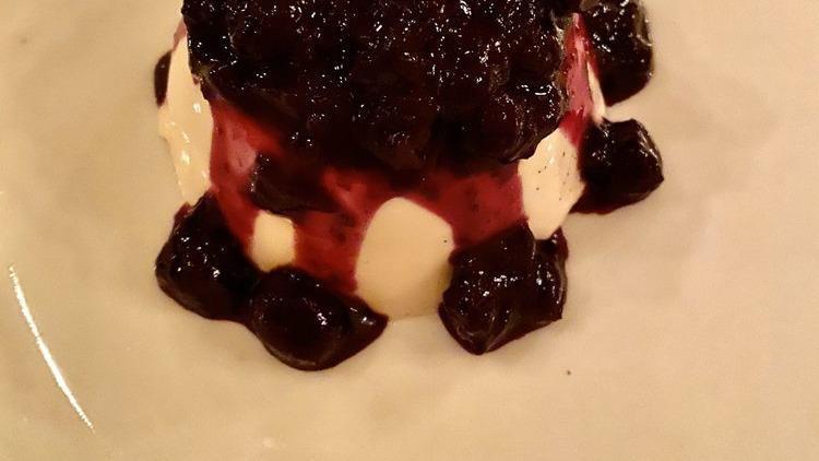 Flourless Valrhona Chocolate Cake · With raspberry coulis and whipped cream.