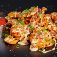 Loaded Waffle Fries · Waffle Fries seasoned in Sam's New Orleans style spice, topped with Cheese Sauce, Bacon Crum...