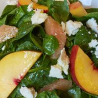 Spinach · Baby spinach, citrus, seasonal fruit, fresh goat cheese, moscatel vinaigrette.