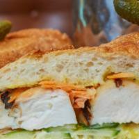 Grilled Chicken Sandwich · Pickled carrots, cucumber, spicy aioli, baguette.
