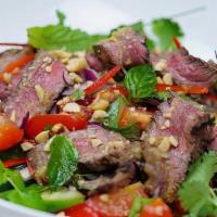 Beef Salad · Yum nua. Grilled sliced beef with red onions, tomatoes, cucumber, scallion and lettuce in a ...