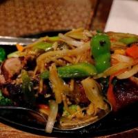 Sizzling Duck · Roast ducks with bell peppers, eggplant and onions in Thai brown sauce.