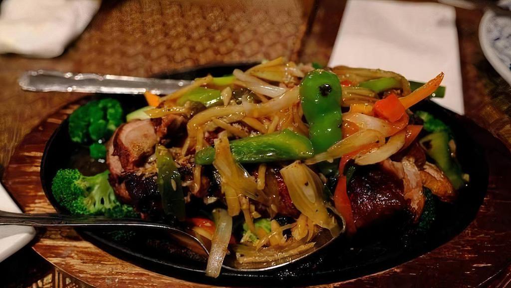Sizzling Duck · Roast ducks with bell peppers, eggplant and onions in Thai brown sauce.