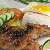 Thai Style Grilled Pork Chop Over Jasmine Rice · Served with hard boiled egg.